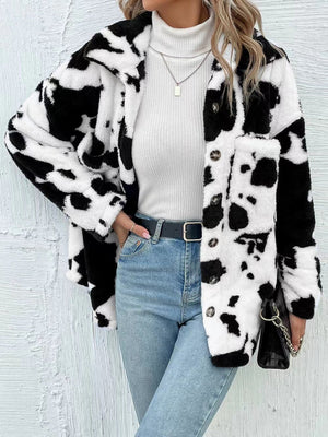 Cow print plush shacket with button front and chest pocket, styled with jeans.