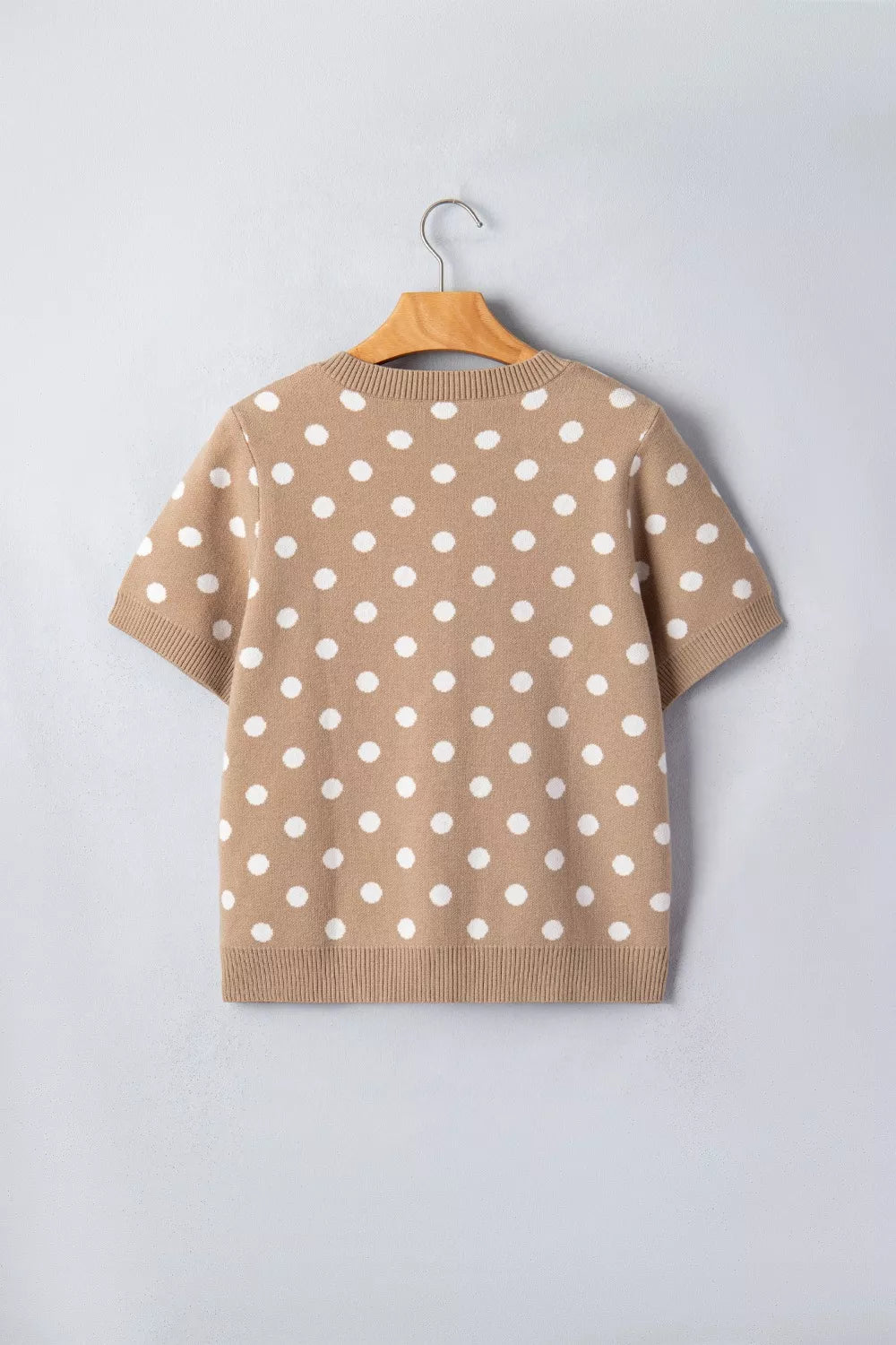 Camel polka dot short sleeve knit cardigan with white dots and ribbed trim.