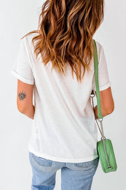 White graphic tee with rolled sleeves and a subtle eye tattoo on the arm.