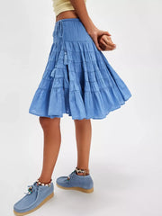 Tiered drawstring mini skirt in Sky Blue with tassel detail and a flowy cut.