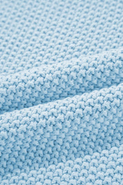 Light blue knit turtleneck sweater detail with textured stitch and soft fabric.