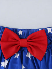 Baby set with red bow and white stars on royal blue cotton blend fabric.