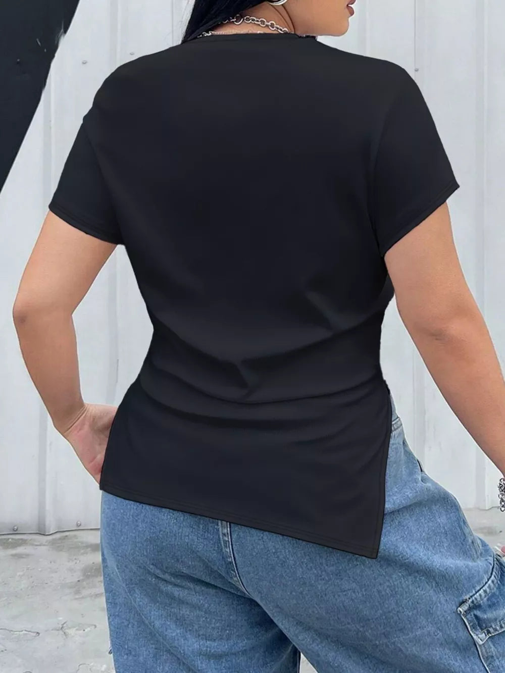 Plus size black asymmetrical t-shirt with short sleeves and side slits.
