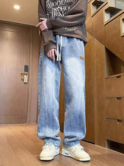 Men's blue vintage wash straight-leg jeans with drawstring and vertical seam detail.