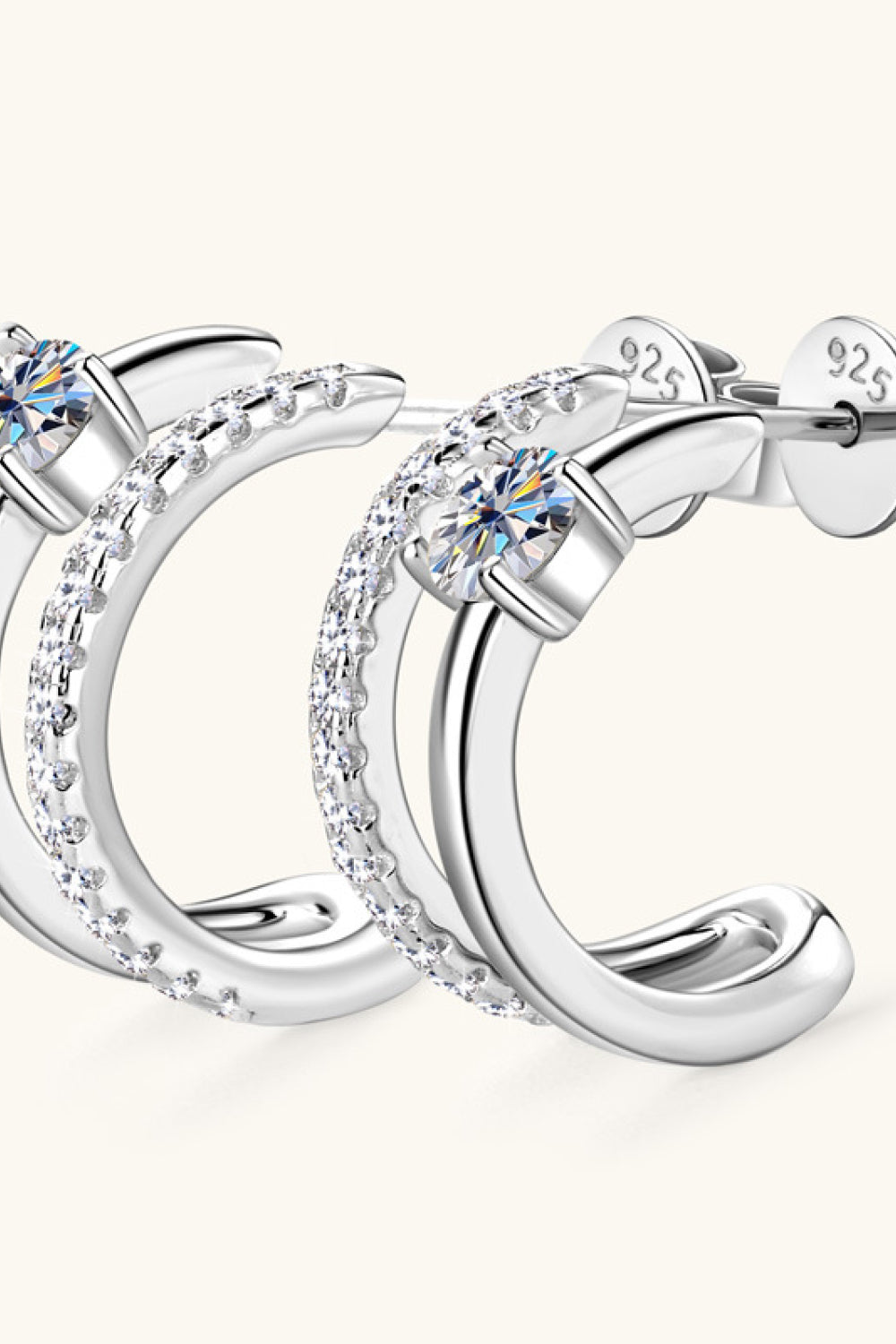Silver double-band hoop earrings with pavé and solitaire stones.