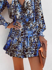 Blue leopard print tiered mini dress with ruffles and smocked waist.