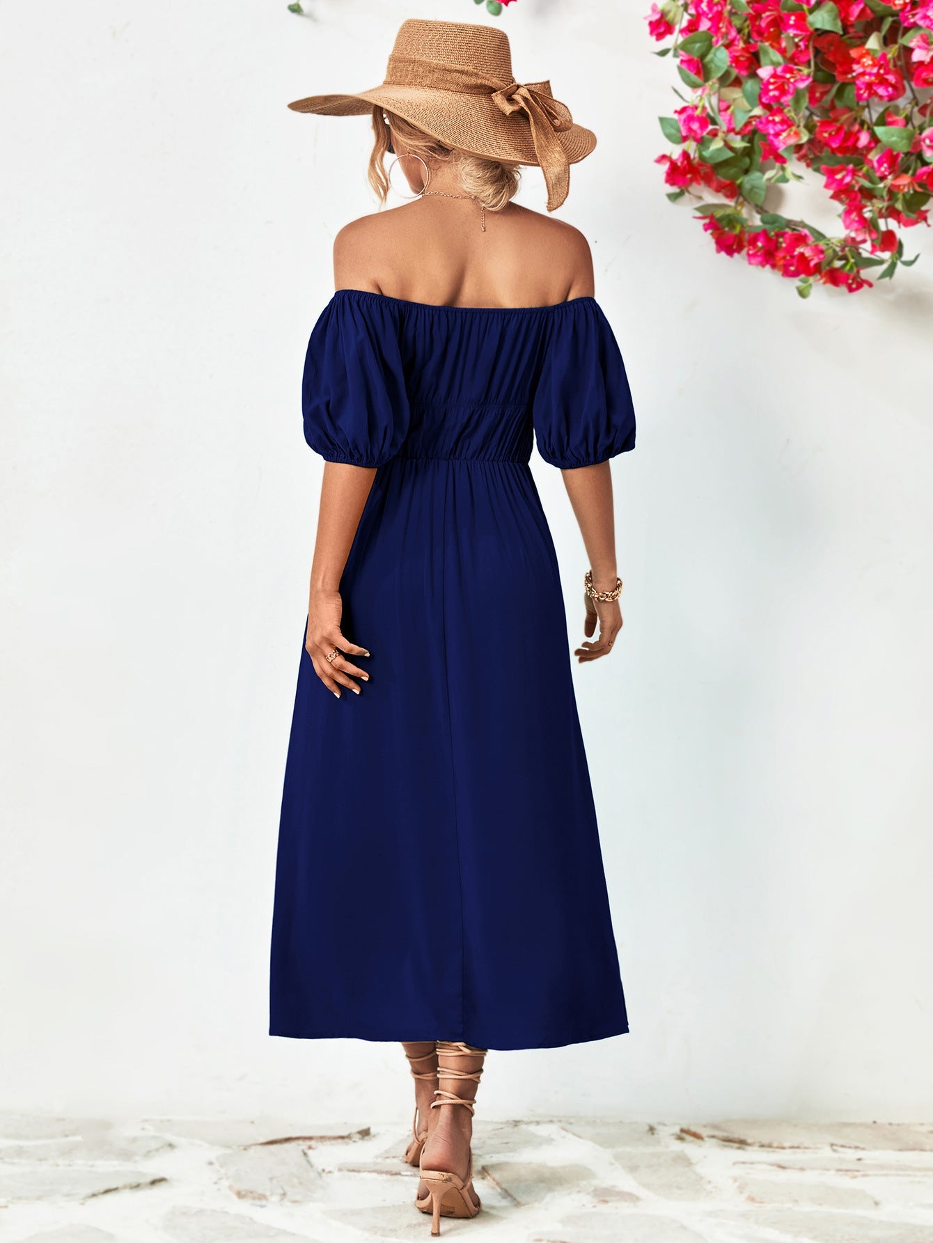 Dark blue off-shoulder midi dress with gathered bodice and balloon sleeves.