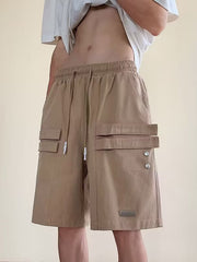 Camel cargo shorts with drawstring waist and multiple flap pockets.