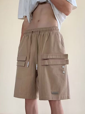 Camel cargo shorts with drawstring waist and multiple flap pockets.