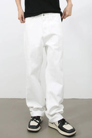 Relaxed fit ivory denim jeans with a modernist silhouette, styled casually.