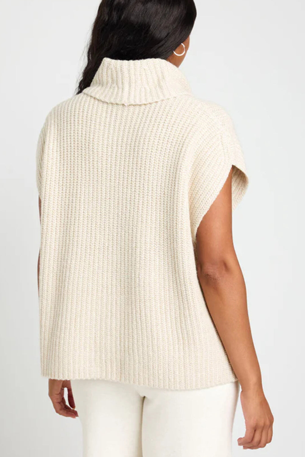 Sleeveless ribbed turtleneck sweater in ivory, casual knit vest with a high neck.