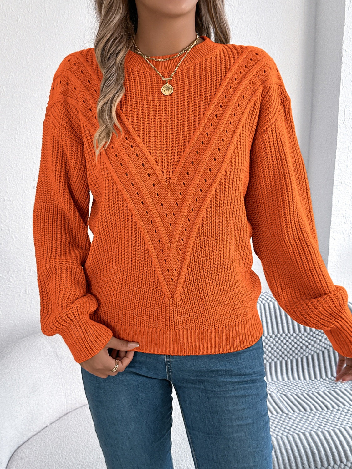 Orange chevron knit sweater with eyelet detail and crew neck.