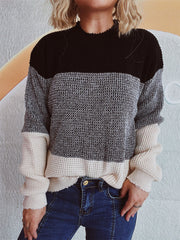 Colorblock textured knit pullover sweater with black, gray, and cream panels.