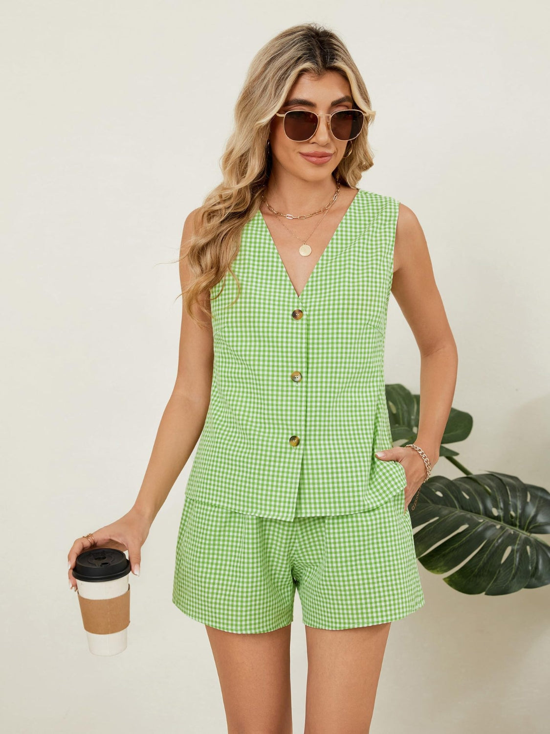 Green gingham linen vest and shorts set with button front and elastic waist shorts.