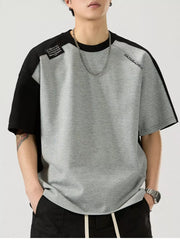 Gray and black color block cotton blend t-shirt with round neck and short sleeves.