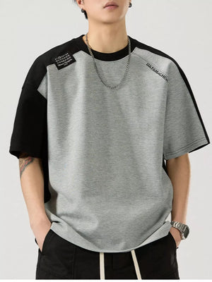 Gray and black color block cotton blend t-shirt with round neck and short sleeves.