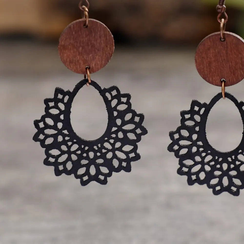 Black floral laser-cut wooden drop earrings with a boho style