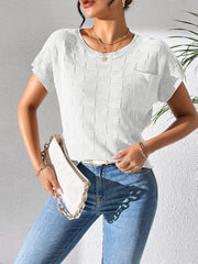 White textured knit pocket tee with short sleeves and crew neck, styled with jeans and a clutch.