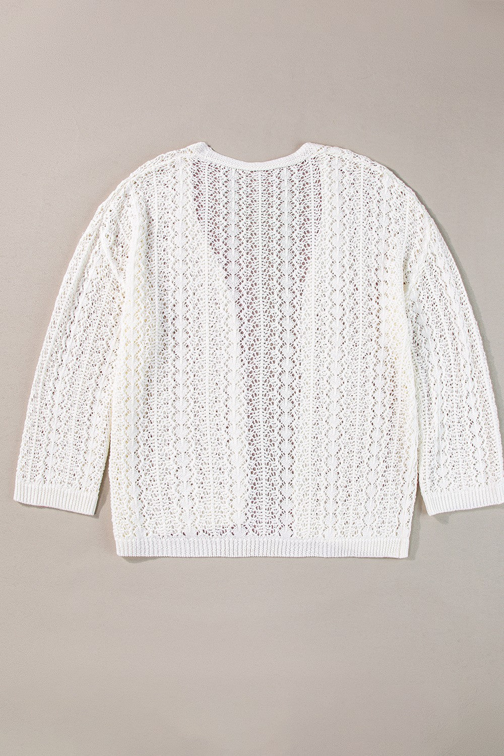 White open-knit crochet cardigan with long sleeves and a V-neck.