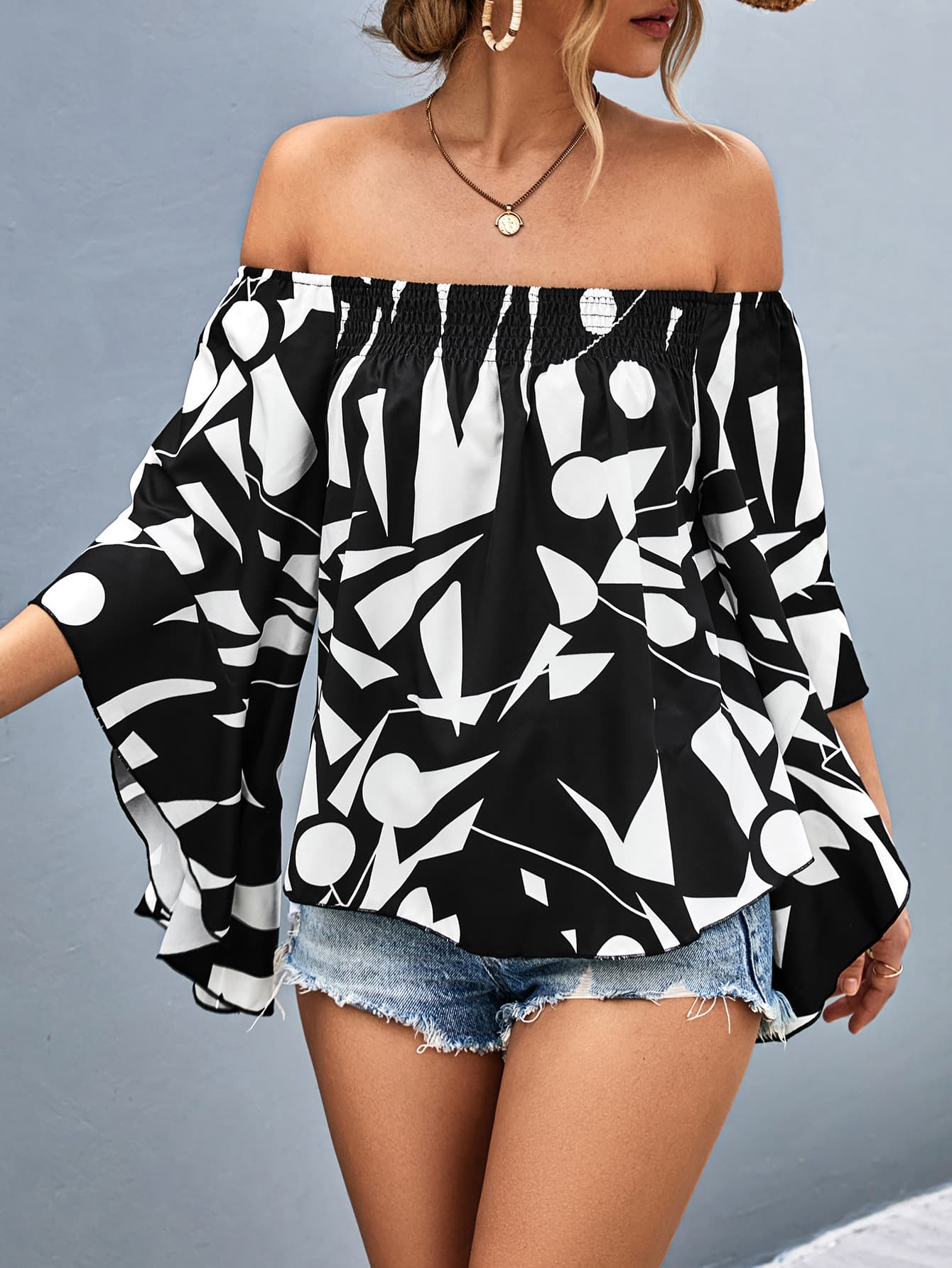 Black and white geometric print off-shoulder blouse with flared sleeves