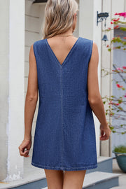 Sleeveless dark wash denim mini dress with V-neck and contrast stitching.