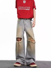 Men's distressed wide leg jeans in light blue denim with ripped knees and a faded wash.