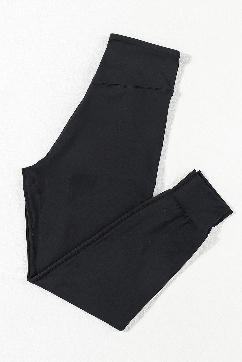 Black performance fit joggers with a comfortable waistband and cuffed ankles.