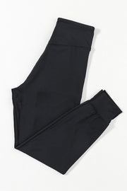 Black performance fit joggers with a comfortable waistband and cuffed ankles.