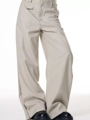 Men's light beige wide-leg cotton sweatpants with a relaxed fit and button closure.