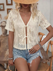 Apricot lace tie-front shirt with floral pattern and short sleeves.