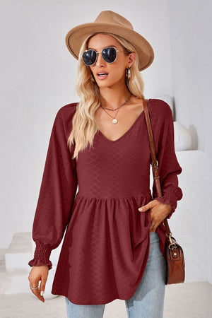 Burgundy textured babydoll blouse with V-neck and smocked cuffs