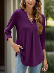 Purple V-neck three-quarter sleeve top with front pleats and a decorative button.