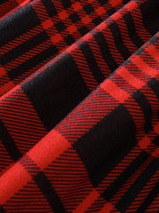 Belted dress in deep red and black plaid fabric, close-up detail.