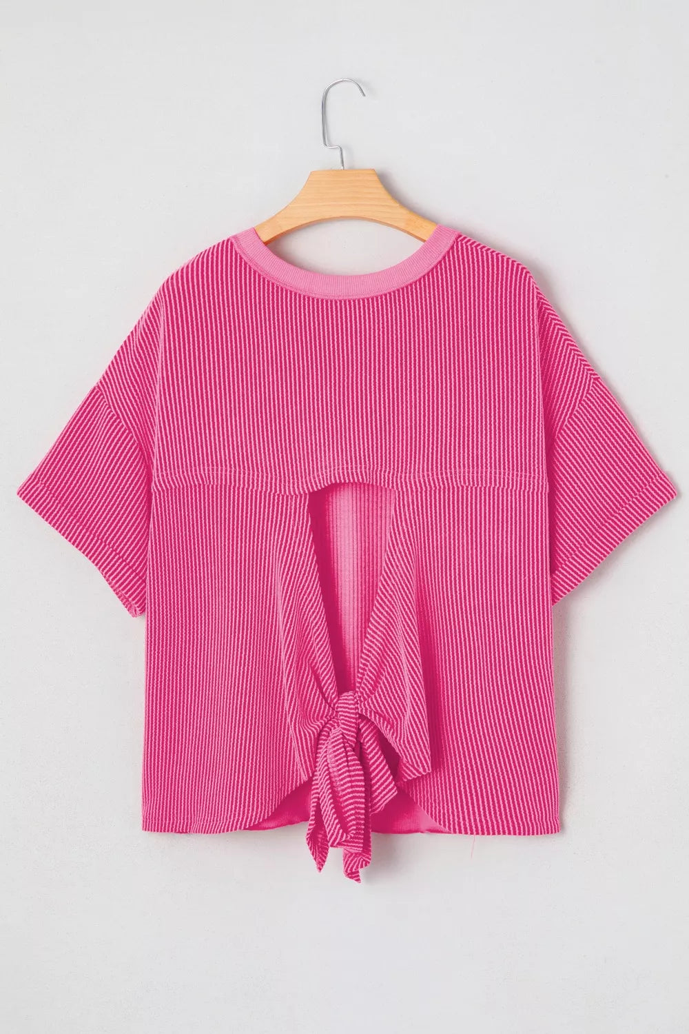 Bold ribbed backless maternity t-shirt in bright pink with a tie-front detail.
