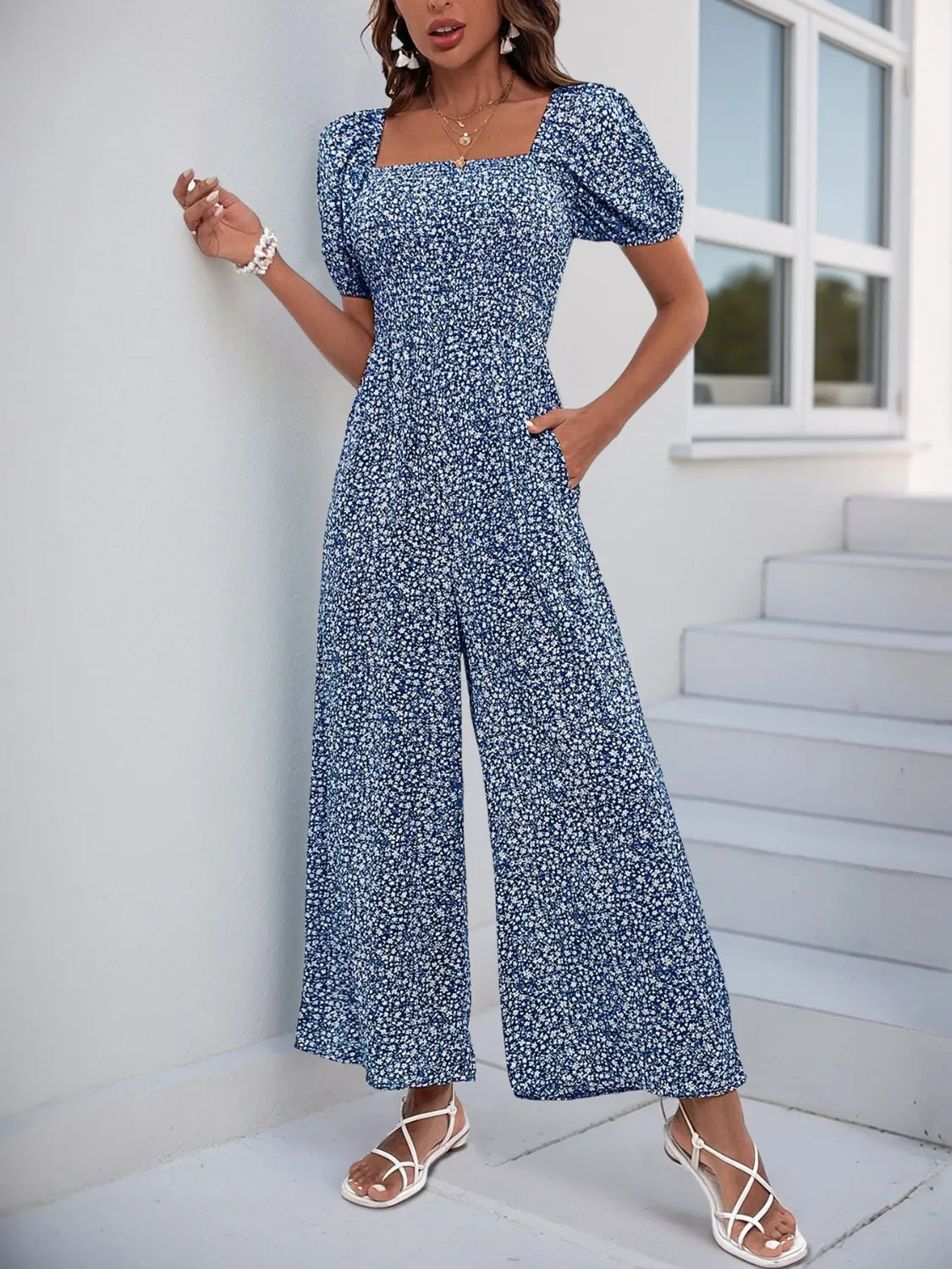 Smocked bodice floral jumpsuit with puff sleeves and wide legs in Royal Blue.
