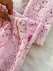 Blush pink lace two-piece ensemble with peplum detail and zipper closure.