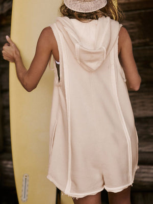Sleeveless hooded romper in tan with raw edges and a relaxed fit.