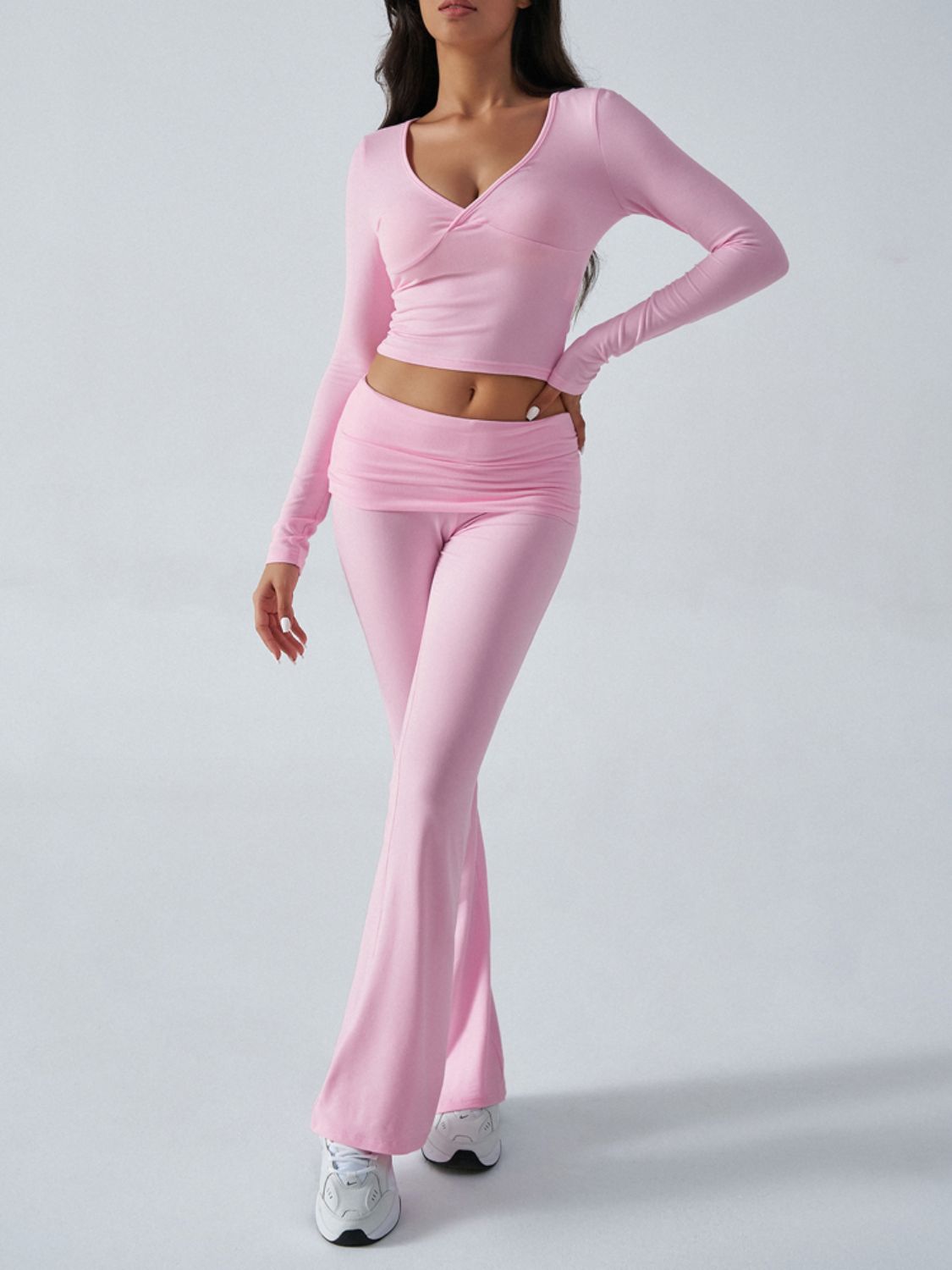 Blush pink cross-front long sleeve crop top and ruched waist flare lounge pants set.