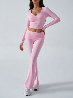 Blush pink cross-front long sleeve crop top and ruched waist flare lounge pants set.