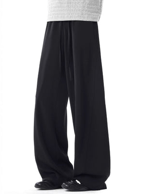 Men's black relaxed wide leg sweatpants with drawstring waist.