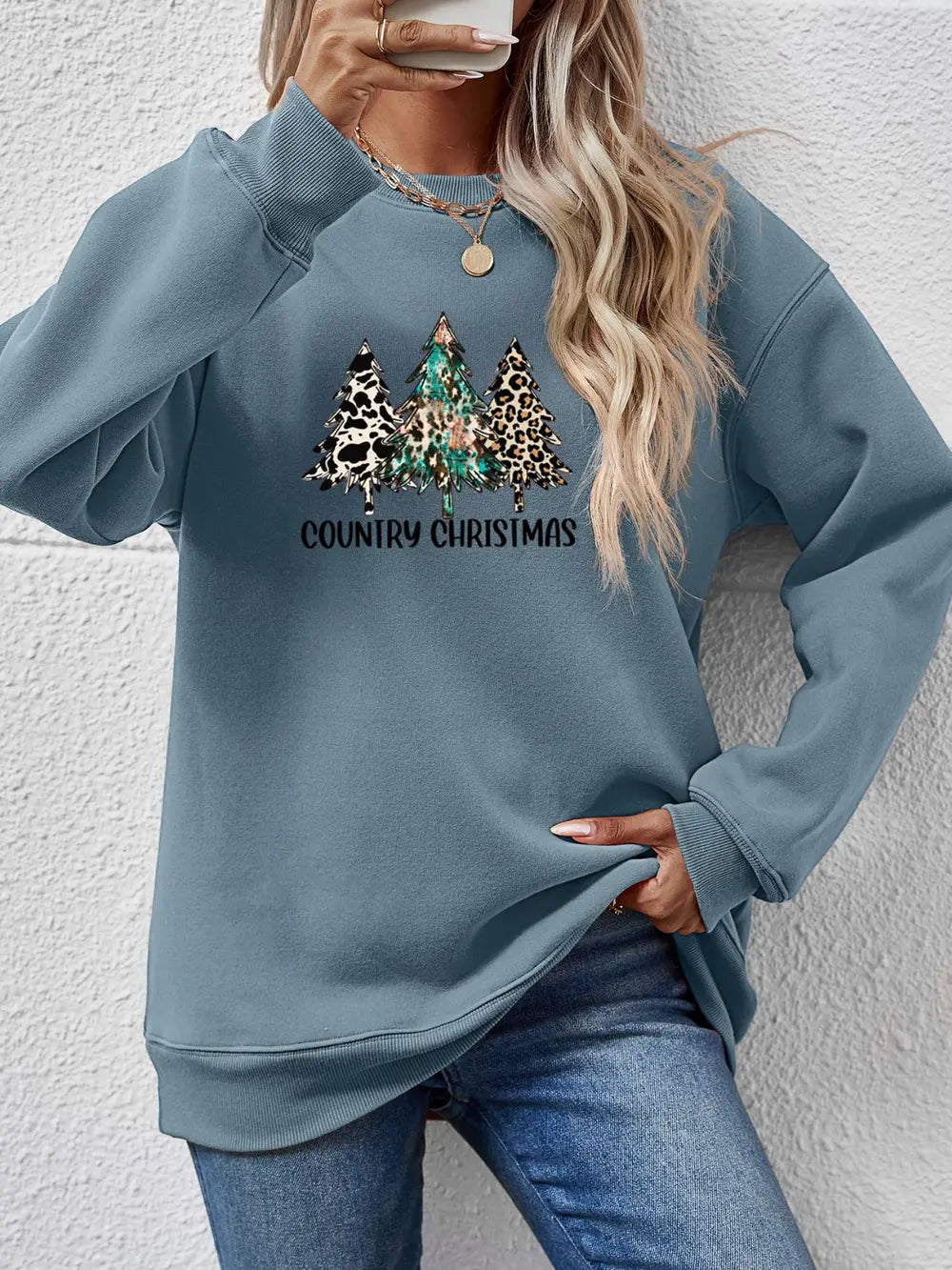 French Blue sweatshirt with country Christmas trees graphic and leopard print detail.