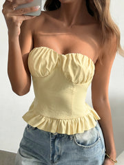 Yellow ruffled hem strapless tube top with ruched bust detail.