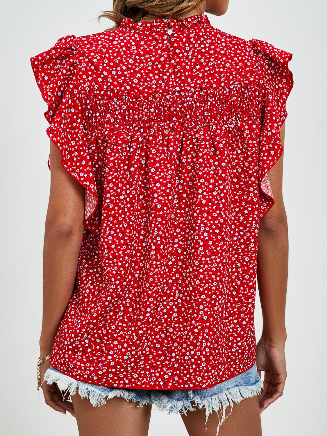 Red floral blouse with smocked yoke and ruffle sleeves.