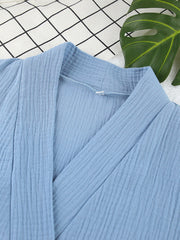 Light blue textured cotton kimono with a V-neckline and wrap front.