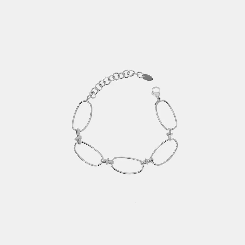 Silver elongated oval link bracelet with a textured chain extender and lobster clasp.