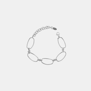 Silver elongated oval link bracelet with a textured chain extender and lobster clasp.