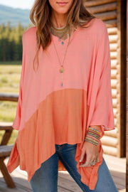 Colorblock drape batwing blouse in sherbet with asymmetrical hem and wide sleeves.