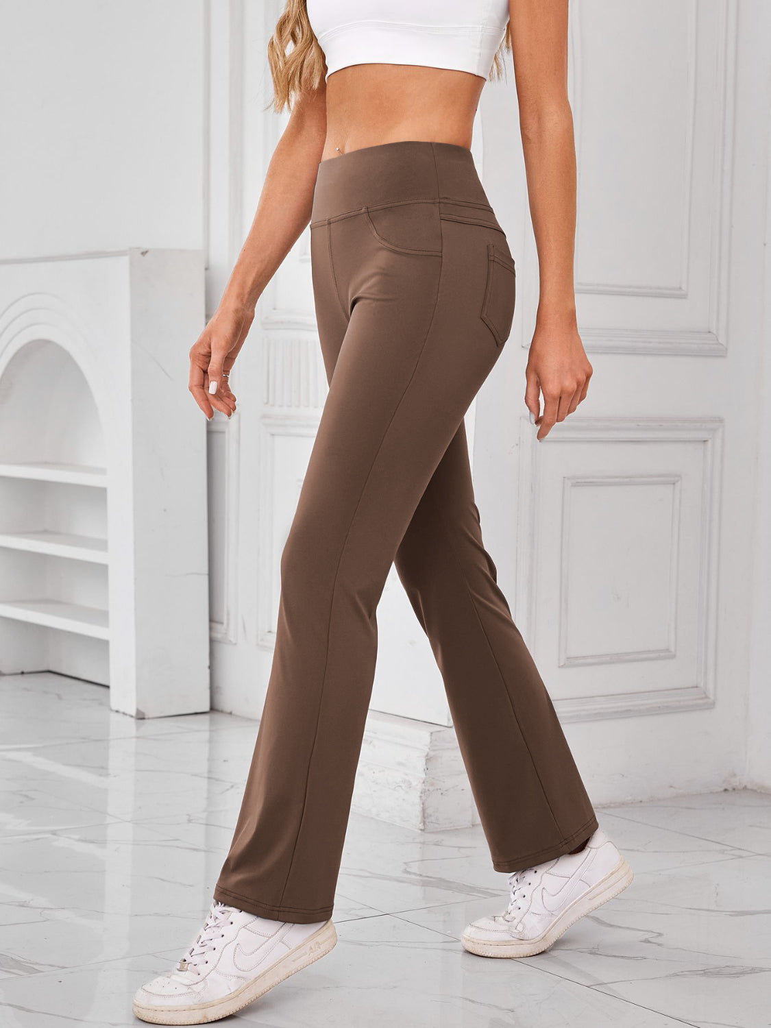 Camel flared activewear pants with pocket detail and high waist.