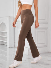 Camel flared activewear pants with pocket detail and high waist.