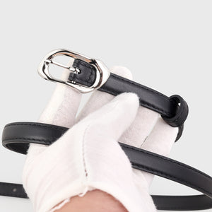 Black leather belt with an irregular silver buckle and loop detail.